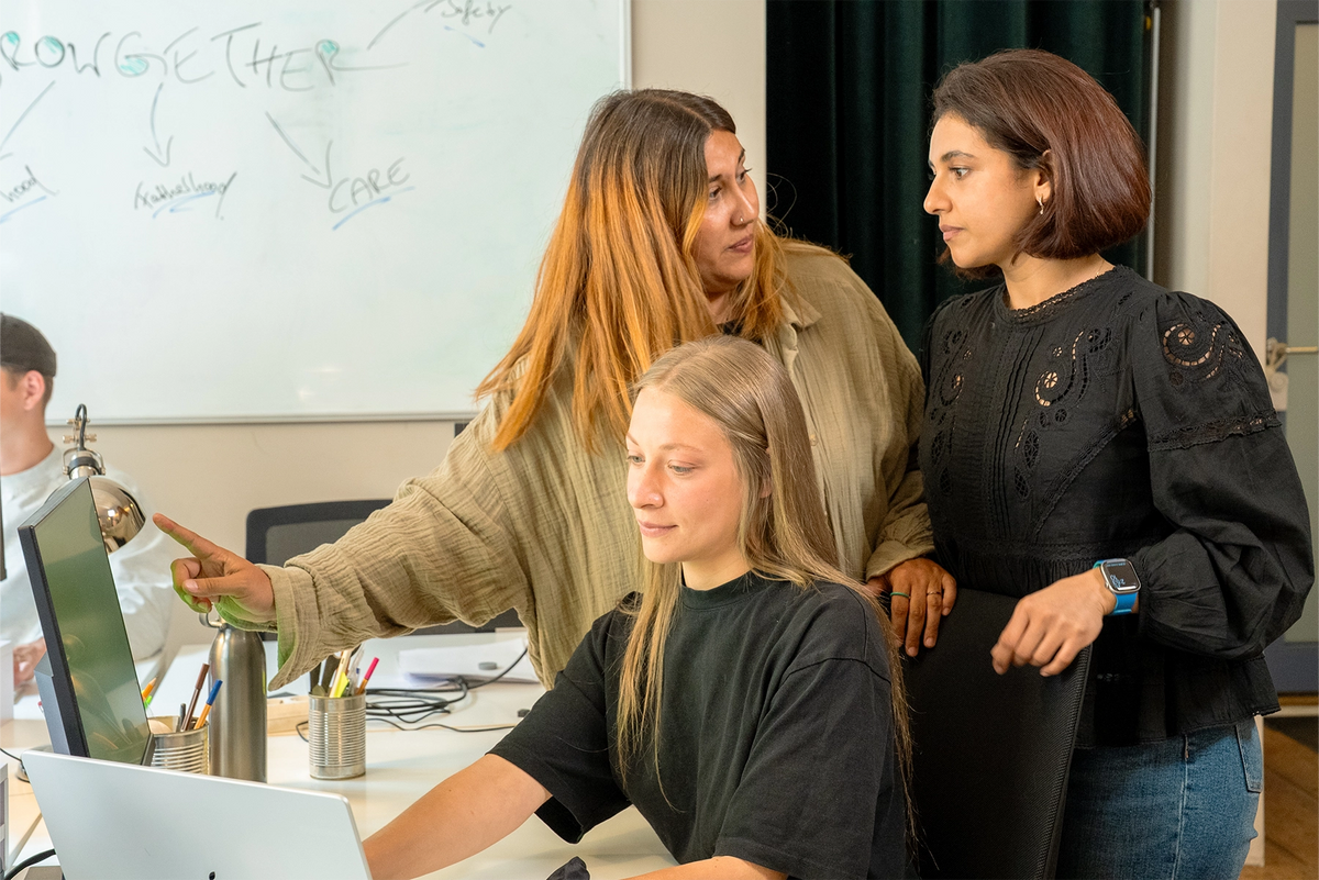 The Growgether team debating the standard at the whiteboard
