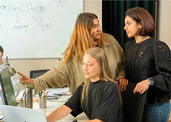 The Growgether team debating the standard at the whiteboard