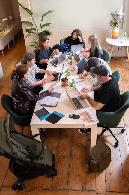 The Growgether team exploring sketches, swatches, and mock-ups around one table