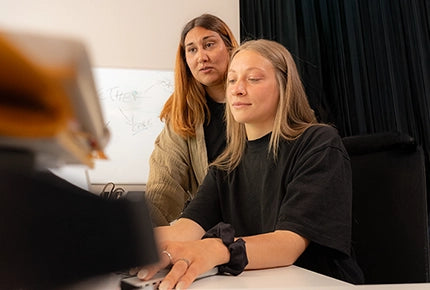Writing the one-line brief in a notebook at the Growgether studio