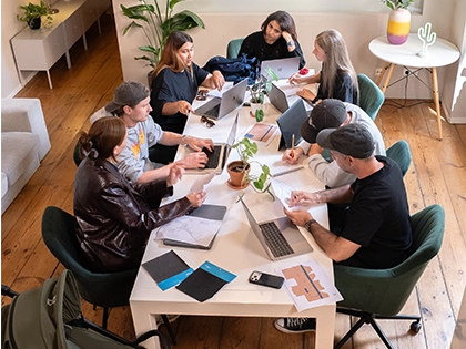 The Growgether team exploring sketches, swatches, and mock-ups around one table